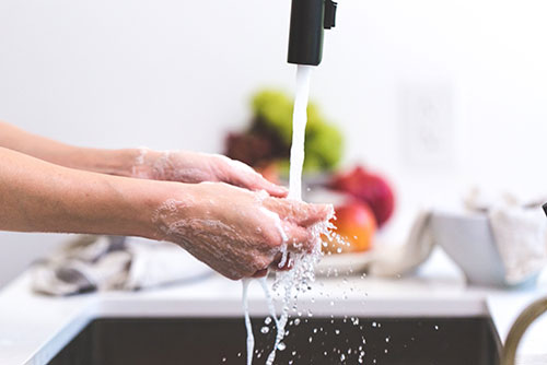 Person washing their hands. Image from Pexels.